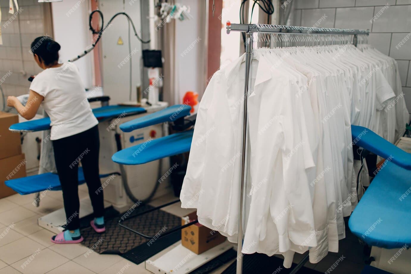 A Lady holding clothes in hanger Lady with clothes in hanger