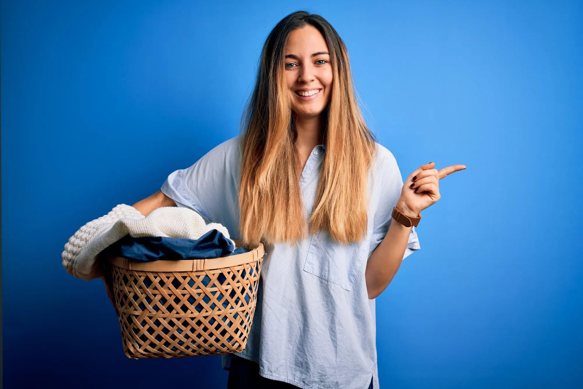 A Lady carrying a bucket of clothes Lady with clothes