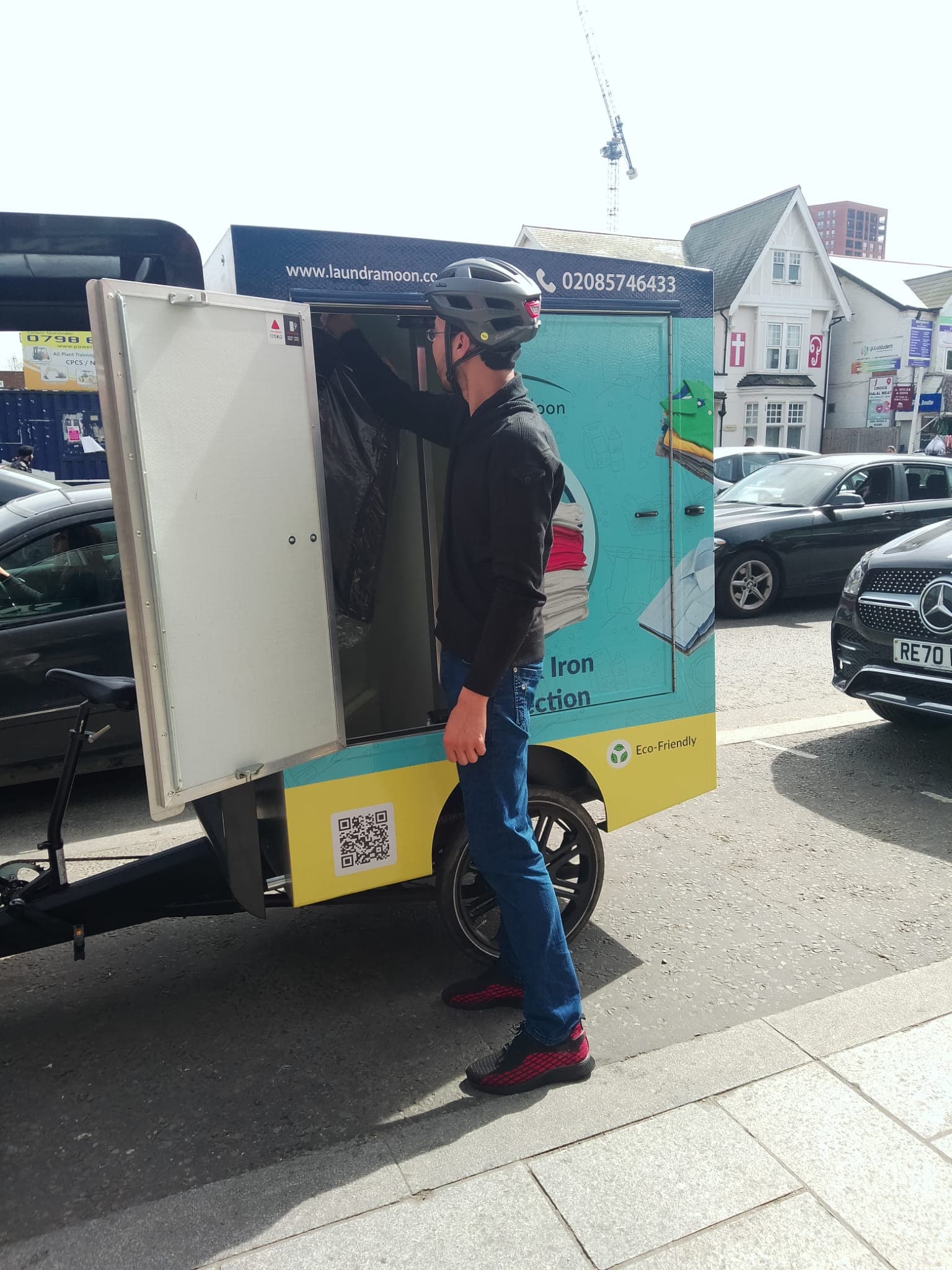 Laundry delivery A laundry courier delivering garments by bike